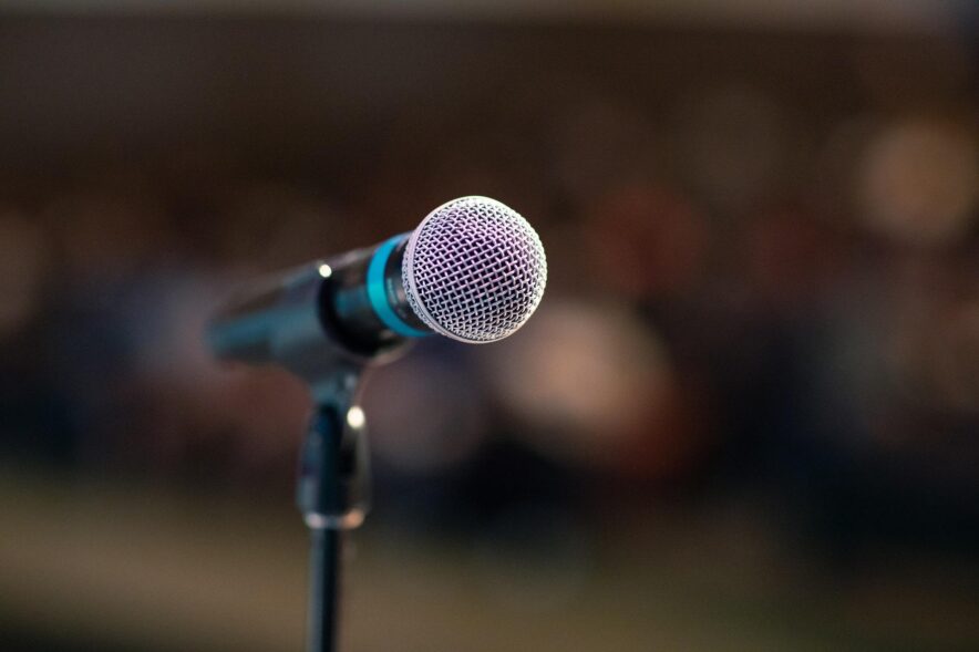 A microphone on a stand waiting for someone to speak into it
