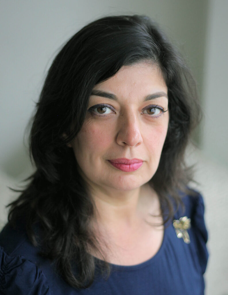 Shazea Quraishi, a Pakistani-born Canadian woman with shoulder-length black hair and brown eyes.